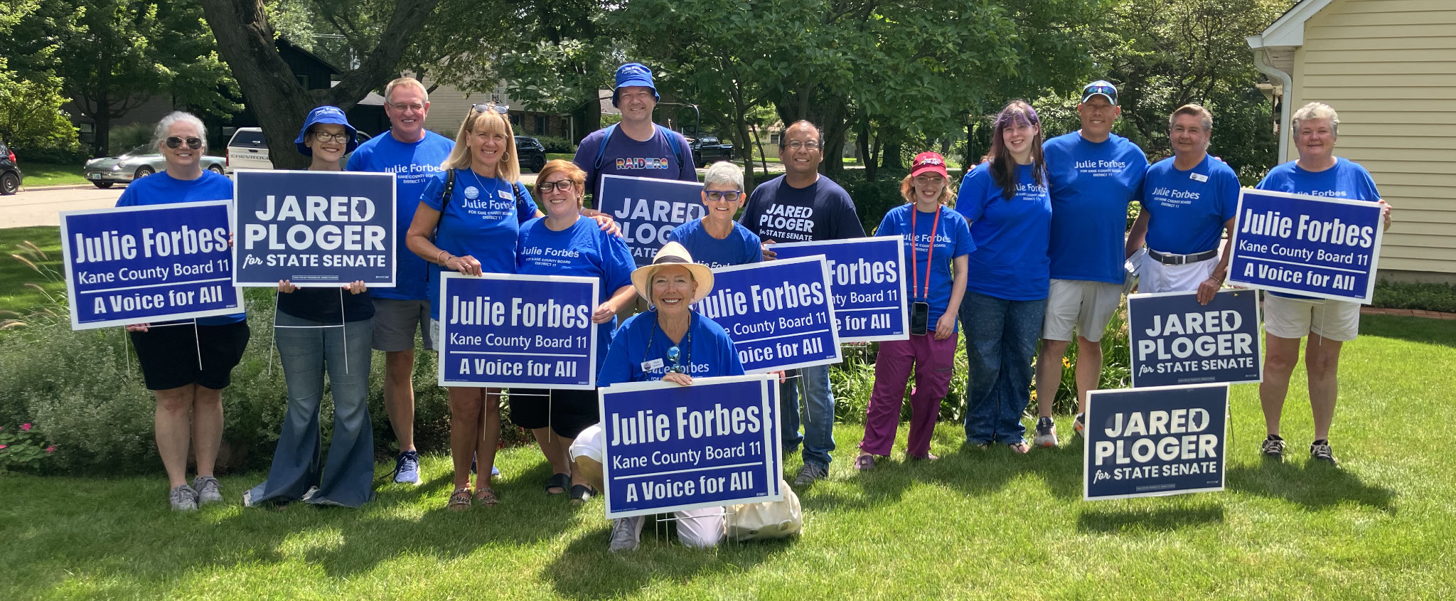 julie forbes team holding signs