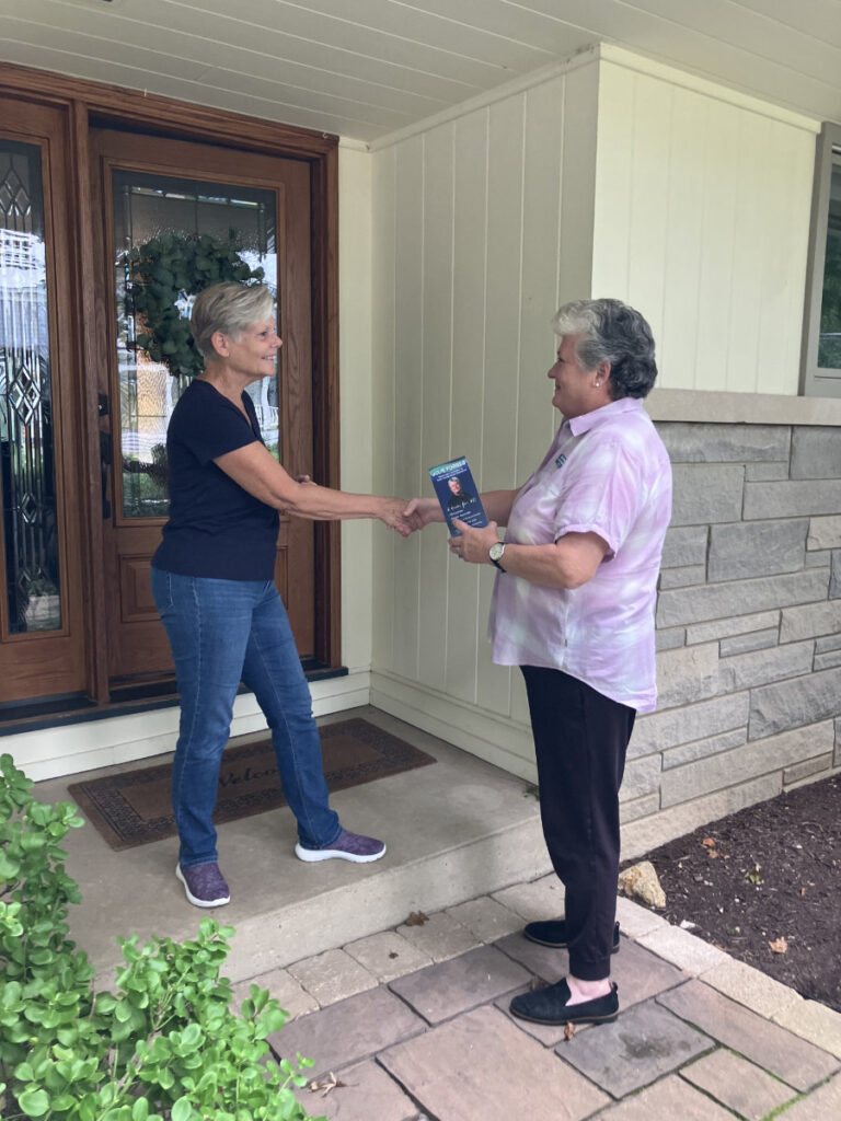 julie forbes talking with a voter at their home
